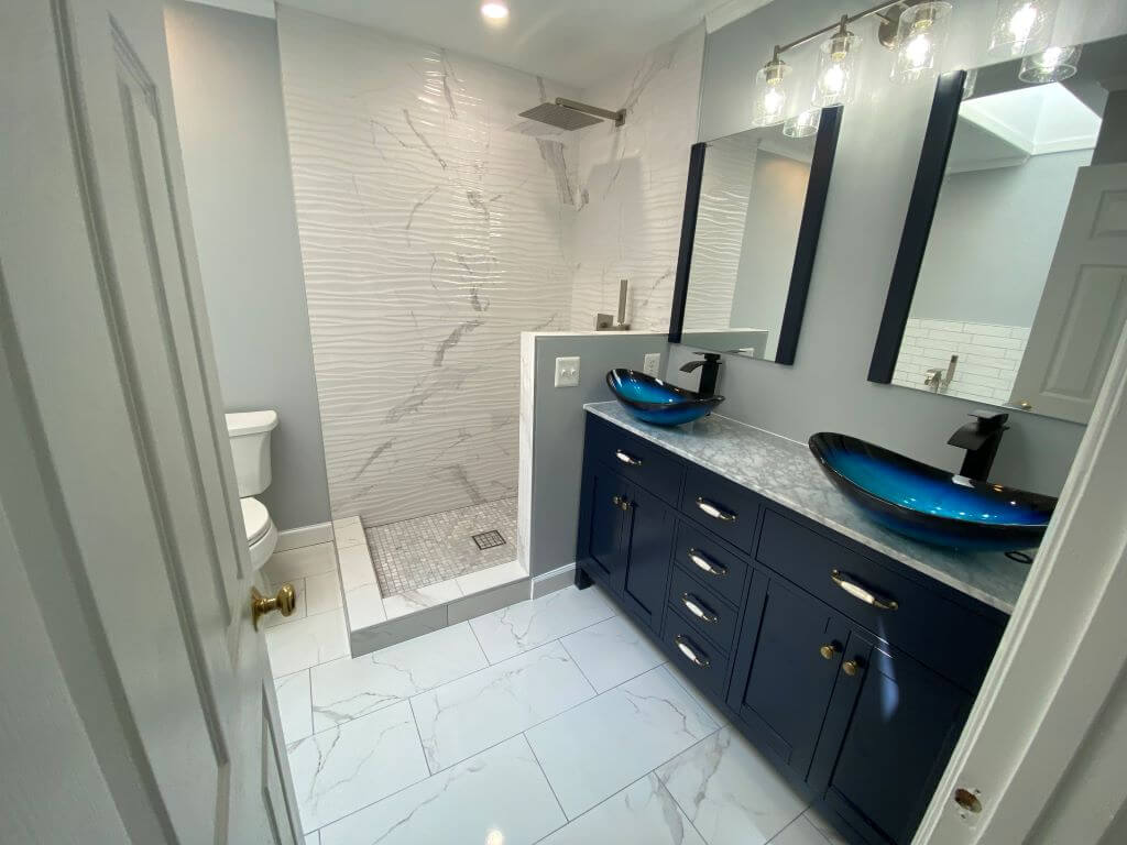 Stylish bathroom renovation in Montgomery County with a walk-in shower and marble tiles.