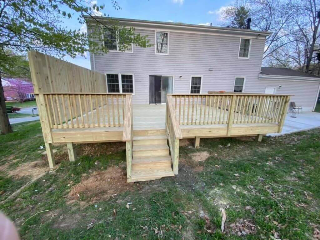 Elegant wooden deck construction in Montgomery County with built-in seating and ambient lighting.