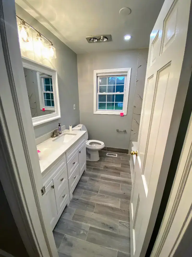 Ashburn, VA contemporary bathroom remodel with large mirror.