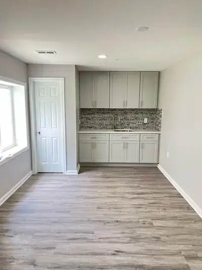 Finished basement with home theater and custom shelving in McLean